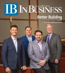 Cover of In Business magazine with four men in suit jackets
